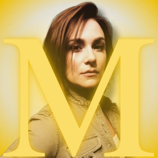 Mercedes Masterson with gold M and gold tones